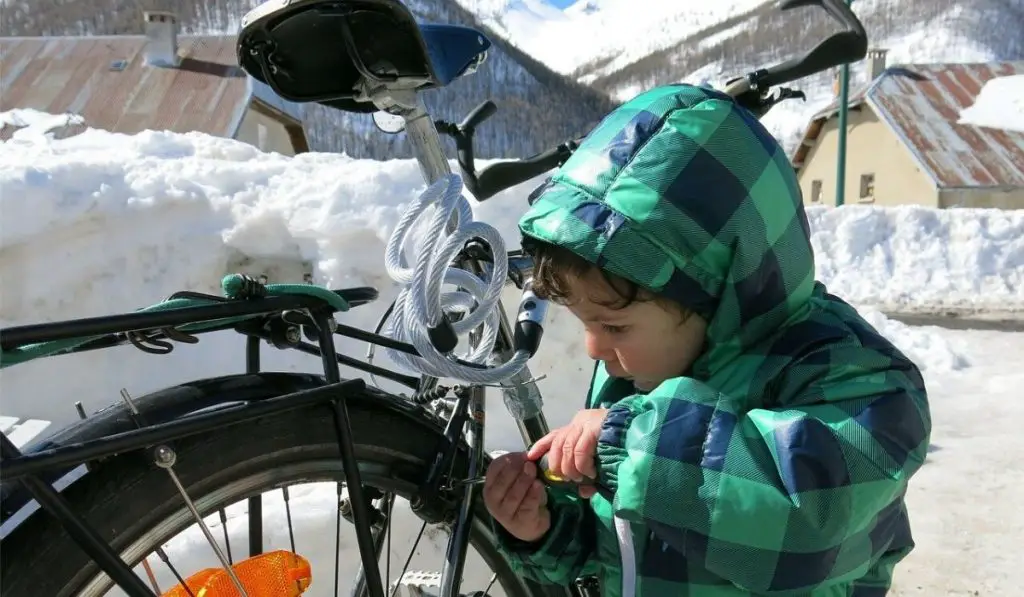 Child repairing a bike