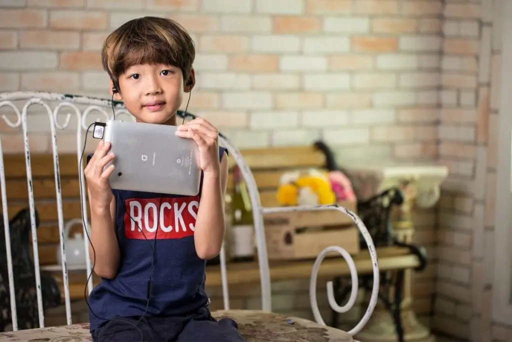 child with tablet and headphone