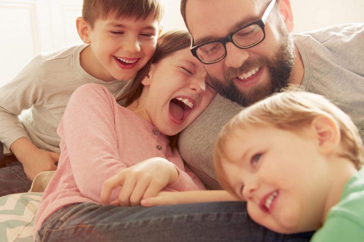 Father laughing with his children