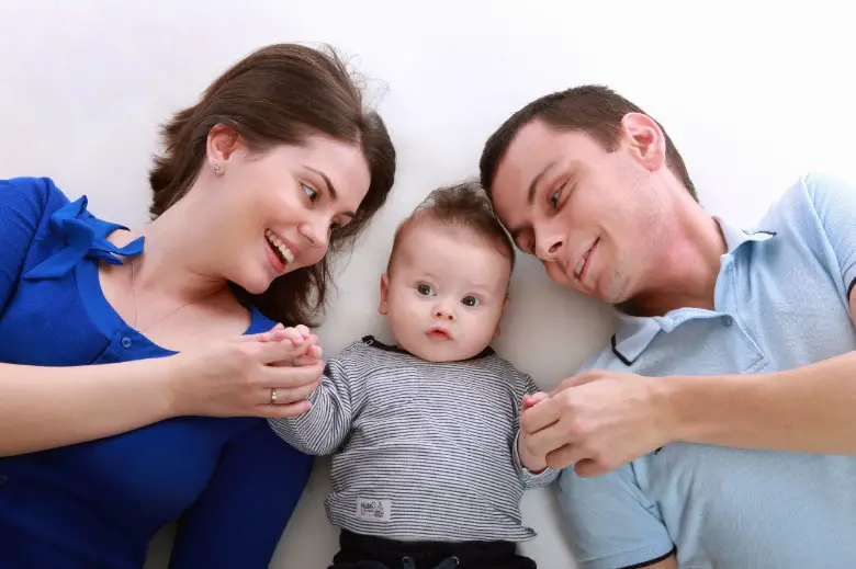 Parents lying with their child