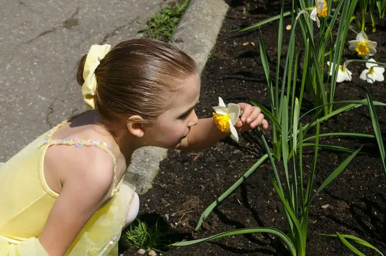 Girl looking at flower