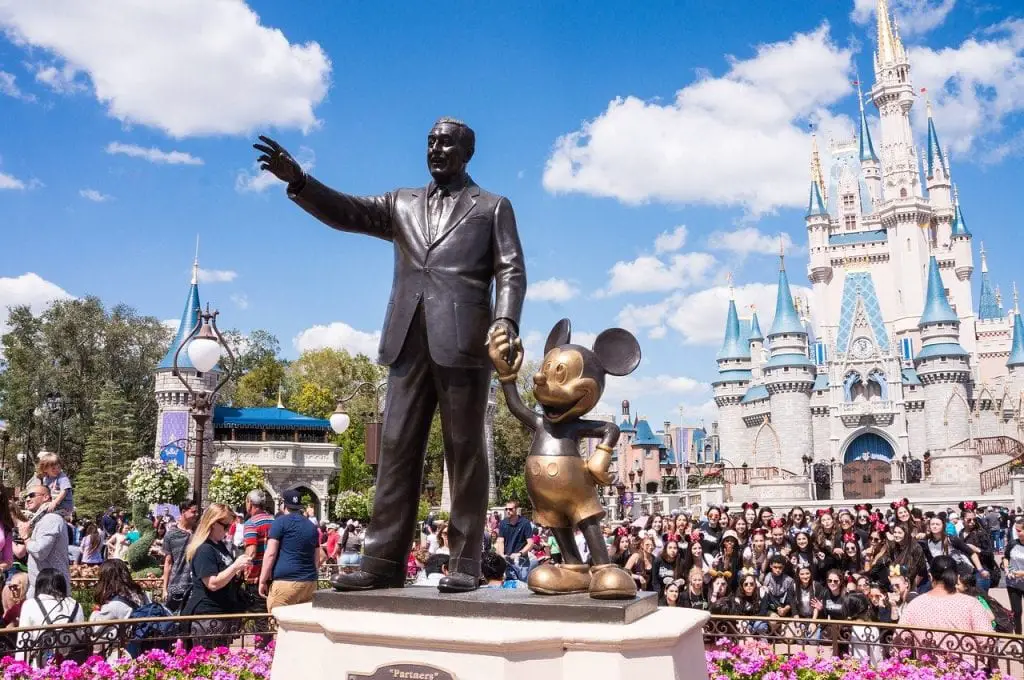 Statue at Disney holding Mickey Mouse' hand