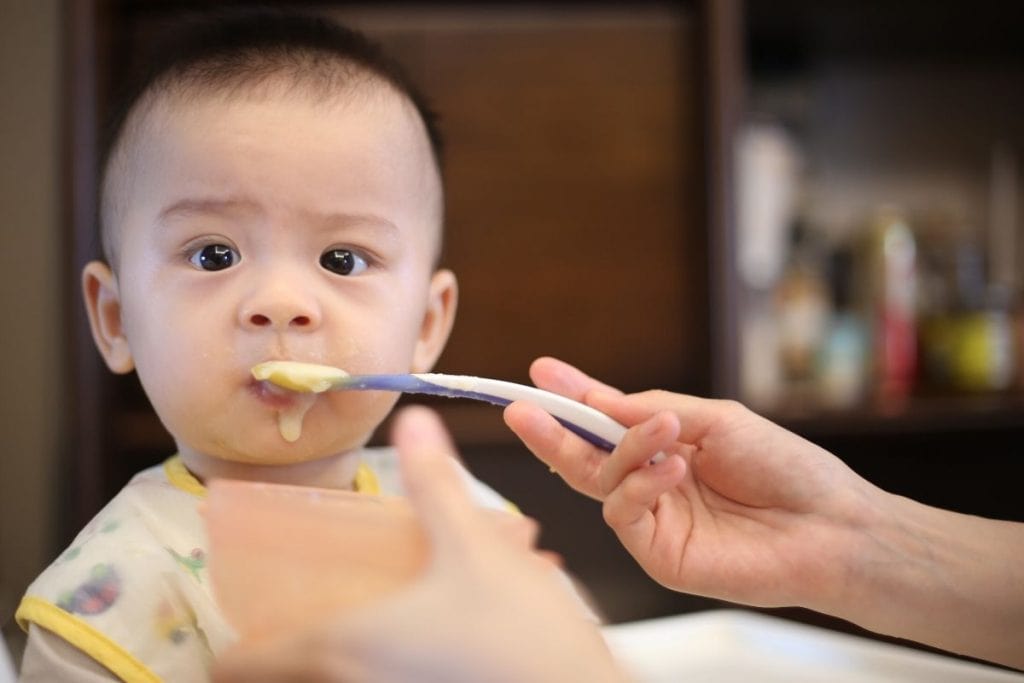 Baby eating with a safe spoon