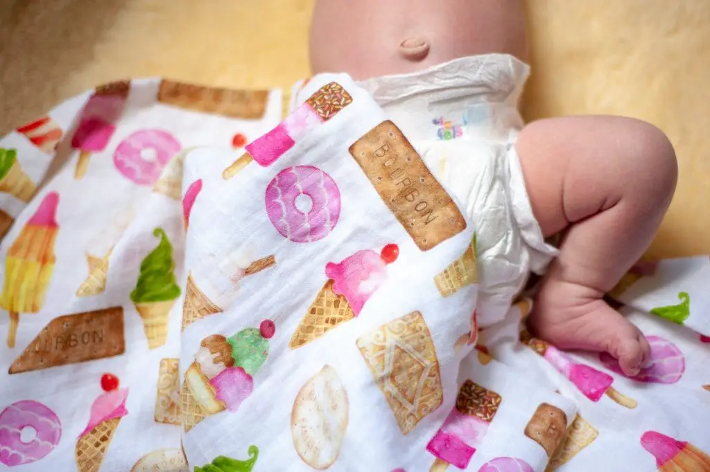 Baby wearing diaper under blanket