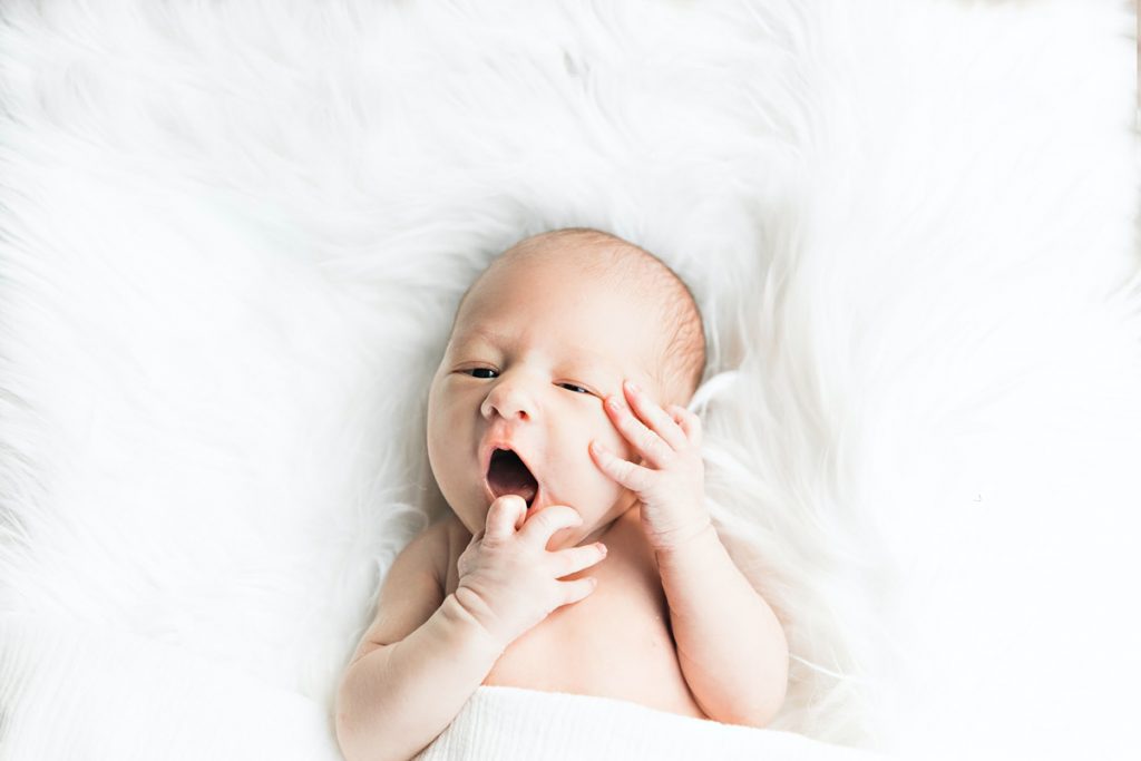 Newborn baby on a white blanket