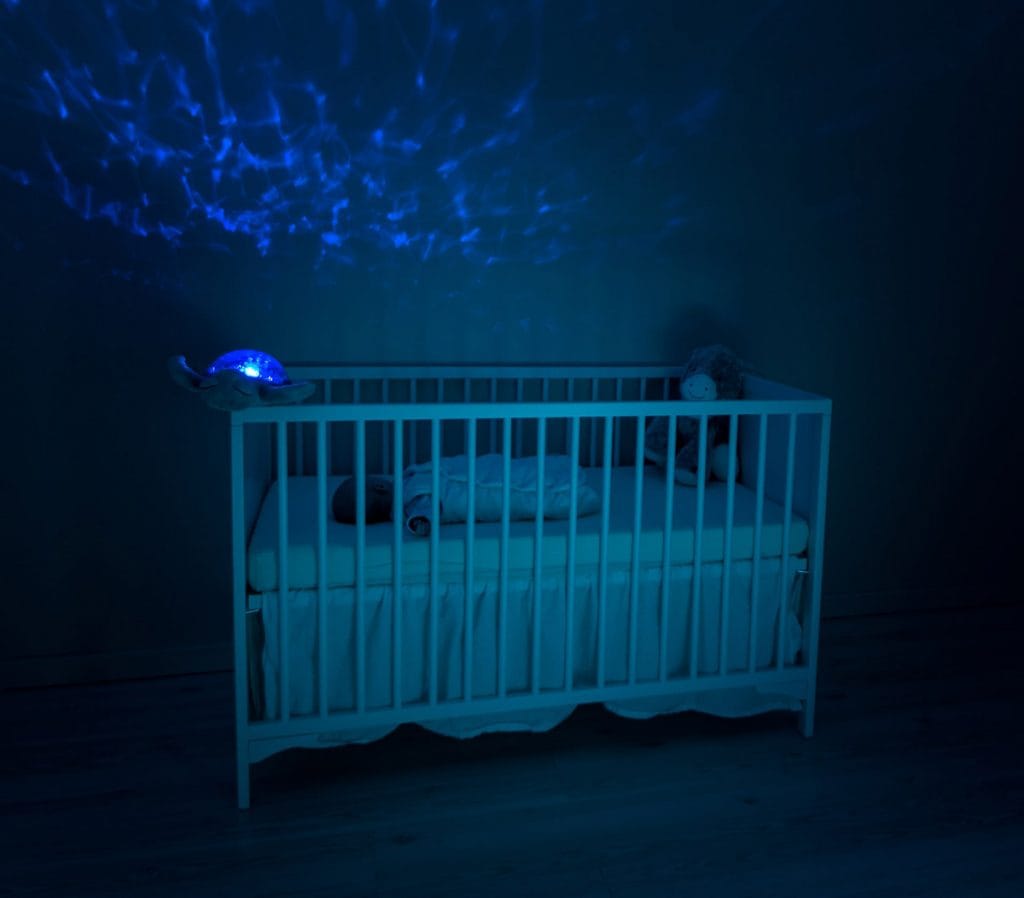 Child sleeping in a crib at night