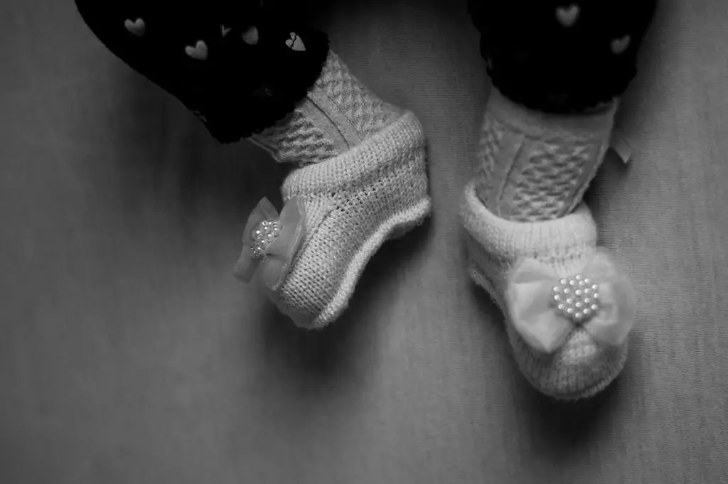 baby feet wearing white socks