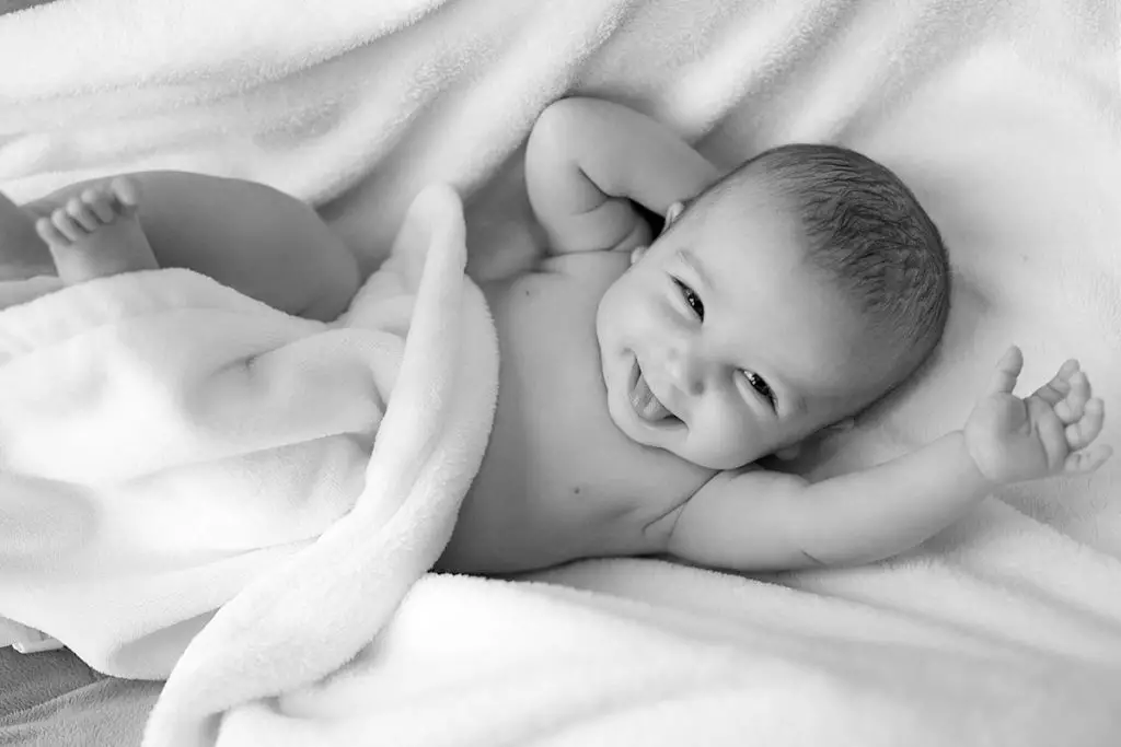 baby lying on smooth cloth black and white effect